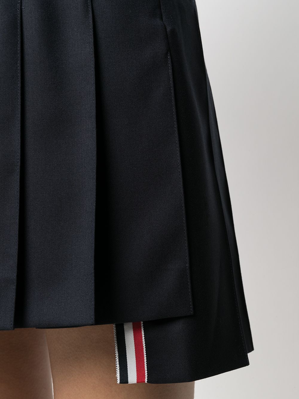 THOM BROWNE Navy Blue Pleated Skirt with RWB Stripe and High-Low Hem